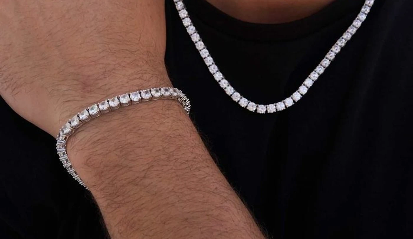 Diamond tennis bracelet on a wrist beside a matching tennis chain
