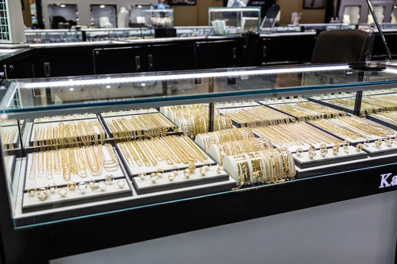 Glass counter filled with gold chains, bracelets and rings at Karats Jewelry