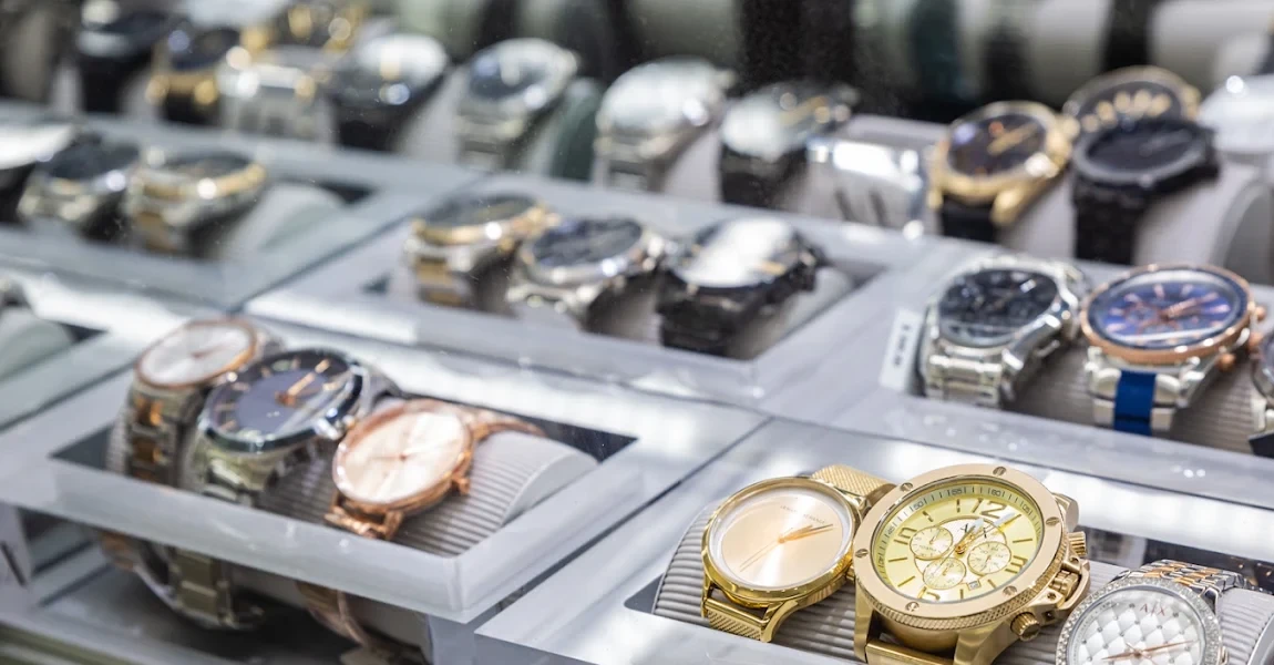 Gold, rose gold and two-tone watches on display cushions