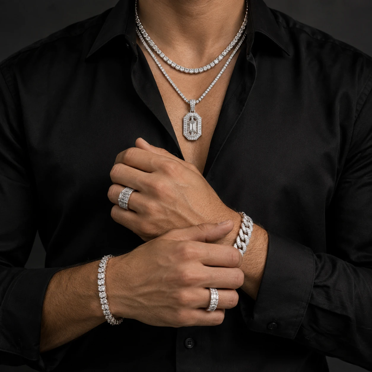 Stacked diamond rings and bracelets worn on crossed wrists