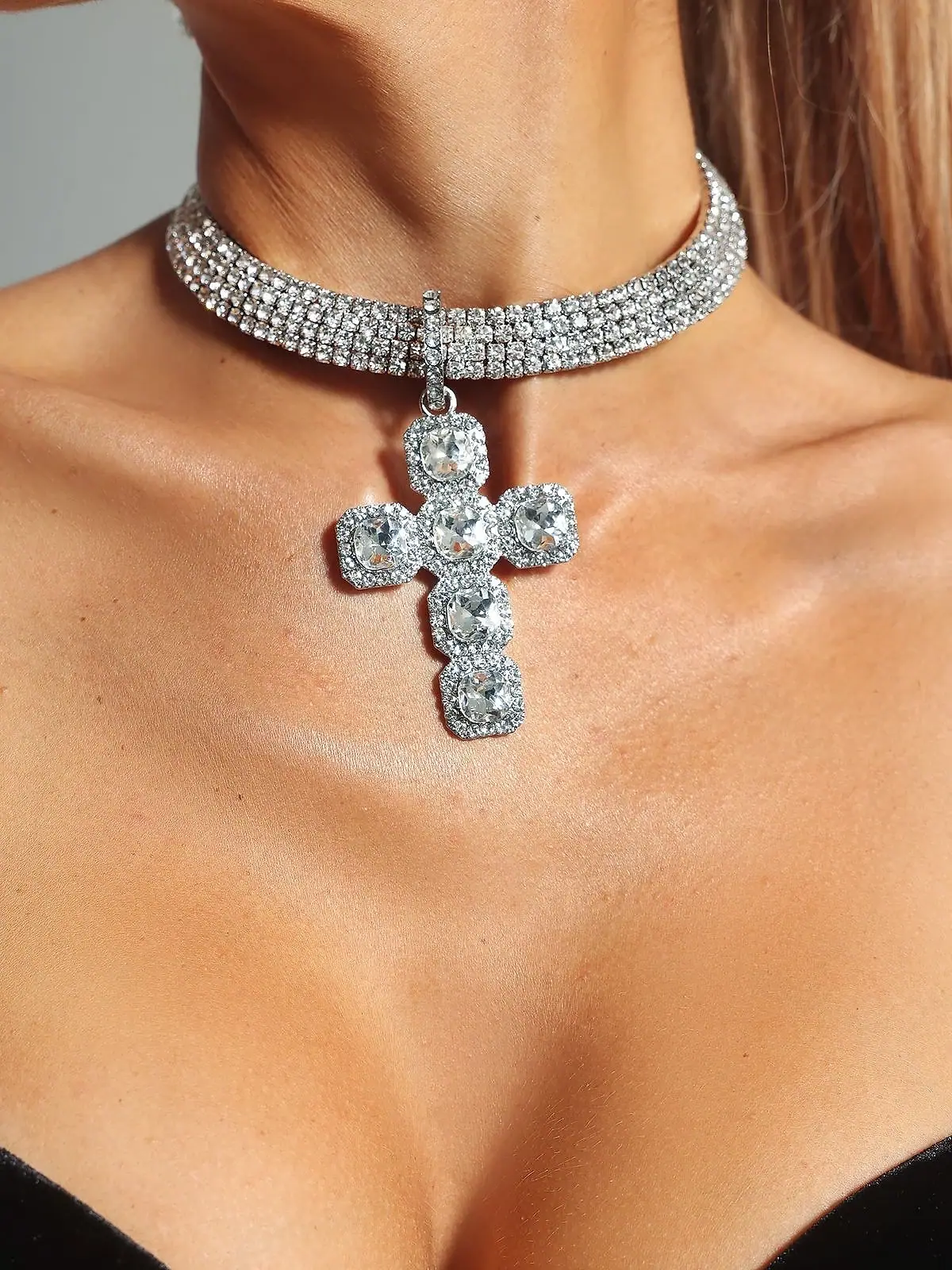 Diamond cross pendant on a four-row diamond choker
