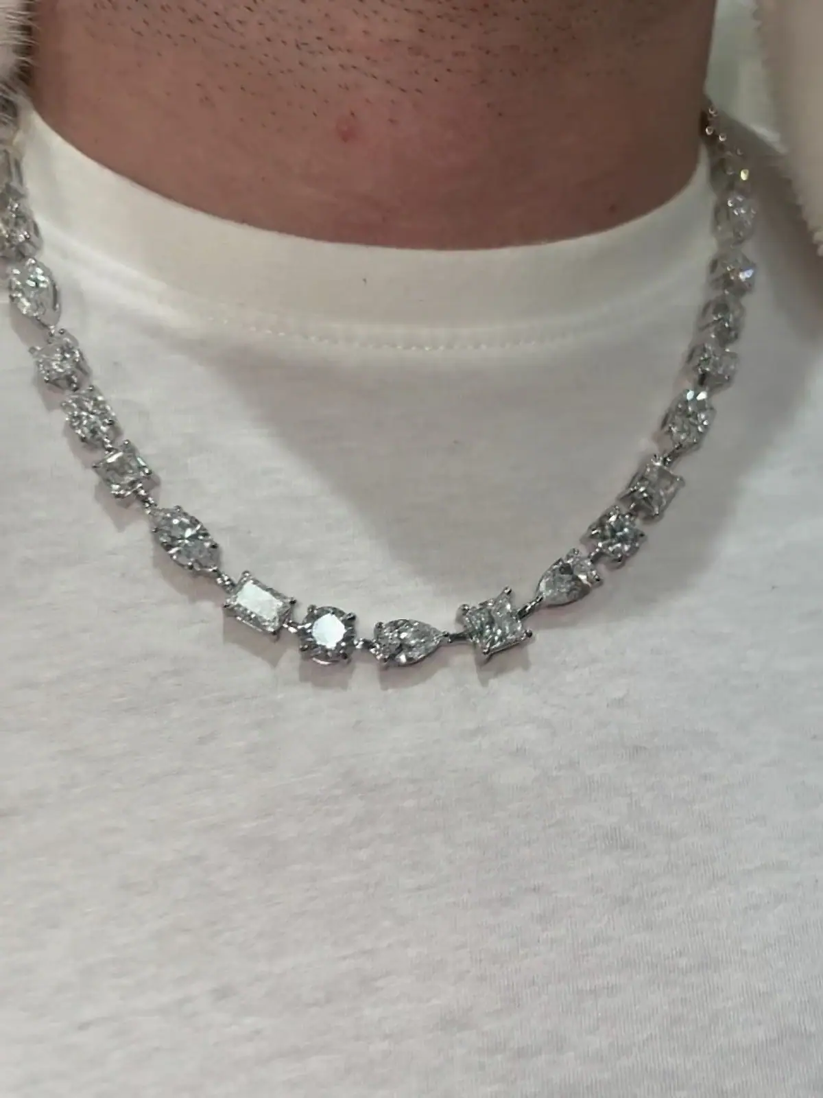 Mixed-shape diamond tennis necklace worn over a white tee